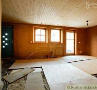 Interior with a wooden ceiling, windows, unfinished floor, and family house.