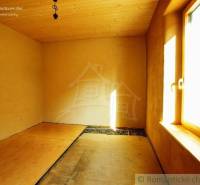 A room with a wooden ceiling and floor, light from the window, natural materials, family house.