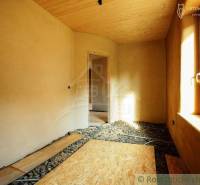 A room in a country house with wooden paneling, preparation for the floor, light through the window.