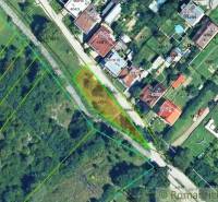 An aerial map shows divided plots and housing in a suburban area with vegetation.