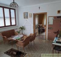 A classic room with rattan furniture, flowers, and windows in a family house offers a cozy atmosphere.