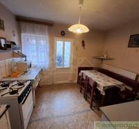 Traditional kitchen with a dining nook and a stove in a family house.