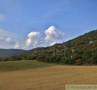 Hills and autumn skies with agricultural and forest lands in the background.