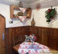 A wooden interior with traditional decorations and flowers in a cottage creates a cozy atmosphere.