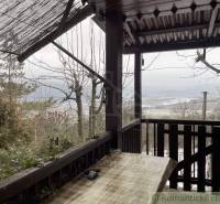 View from the cottage to the snowy landscape, set in a natural environment.