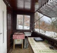 A covered porch with a view of the snowy landscape, a great place for rest and relaxation.