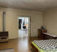 Room, bed, carpet, stove, antique furniture, family house.