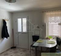 Kitchen, family house, dining table, chairs, entrance door, coat rack, broom, tiles.