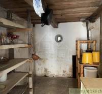 A country pantry full of shelves and kitchen utensils in a family house.