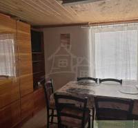 Interior of a cabin, retro furniture, wooden ceiling, dining table with chairs.
