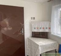 Brown door, table with a tablecloth, set in the cozy environment of an attic cabin.