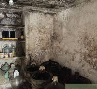 An ancient cellar with bottles and jars, suitable for storage in a cottage.