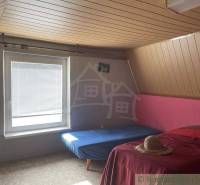 Attic room with a wooden ceiling, comfortable beds in a cottage ideal for a vacation.