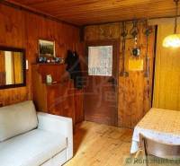 Wooden interiors with a sofa and dining table, cozy atmosphere, cabin for relaxation.