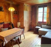 Wooden interior with cozy seating and decorative lamps in a mountain cabin.
