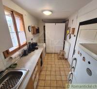 Kitchen unit with appliances, spacious storage cabinets, tiles. Family house with a kitchen.