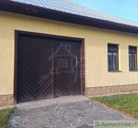Yellow building with double doors and two windows for sale as commercial premises.