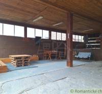 A spacious terrace of a family house with wooden ceilings, seating, and a pleasant atmosphere for relaxation.
