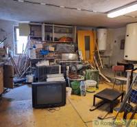 An old warehouse with tools, a television, and two boilers offers limited commercial space.