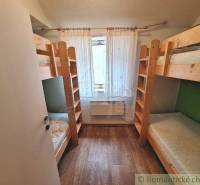 Bunk beds made of light wood in a small room, accessories for commercial spaces.