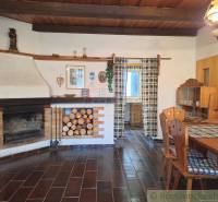 The interior of the cottage features a stylish fireplace, wooden furniture, and decorations. Family house.