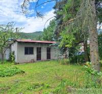A family house surrounded by greenery on a peaceful plot, suitable for relaxation and living.