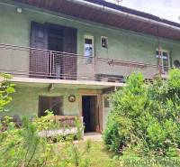 A two-story house with a terrace, surrounded by lush greenery, ideal for living. The plots offer tranquility.