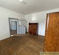 A room with wooden floors and antique furniture in a family house.