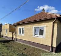 A family house with a brick gable roof in a peaceful village location.