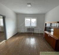 A room in a family house with older furniture and well-preserved wooden floors.
