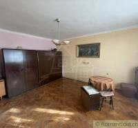 A room in a family house with furniture, a painting, and a TV, suitable for living.