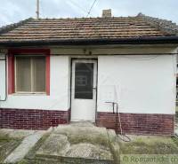 Older family house with a brick facade and a tiled roof, entrance area.