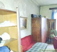 Interior of the room: old furniture, bed, armchair, living room in a family house in the village.