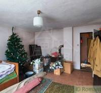 A room with a bed, family house, Christmas tree, boxes, furniture. Cottage atmosphere.