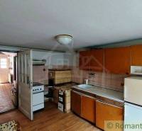 A kitchen in an older family house with classic cabinets and basic equipment.