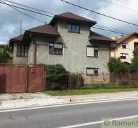 A family house with traditional architecture, situated by the road, in a quiet environment for living.