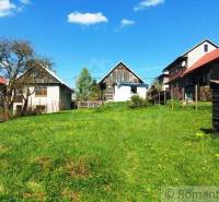 Country cottages on a green meadow, offering peace and unique properties.