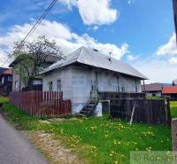 A village with a cottage, a fence, and a road, ideal for unique rural properties.