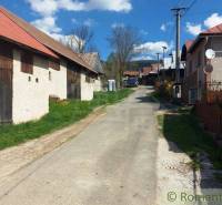 Old wooden and stone buildings along the alley, peculiar properties in the village.