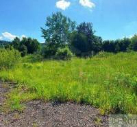 The picture shows green plots surrounded by nature, ideal for living in a quiet environment.