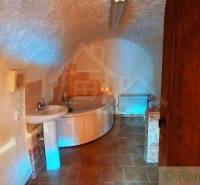 Underground bathroom with antique-style furnishings and unique vaulted ceilings. Unique properties.