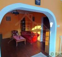 Living room with a vintage sofa and colorful walls, creating a unique property.