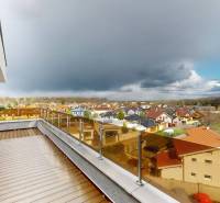 View from the terrace of a 4-room apartment on Brezová Street in Malacky, with a dark sky.