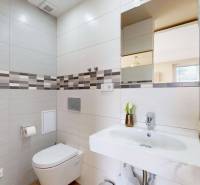A bathroom with a shower and a sink in a 4-room apartment.