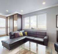 Living room with a gray sofa and a work corner in a 4-room apartment.