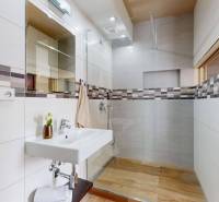 A bathroom in a 4-room apartment with a shower and ceramic tiles.