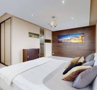 A bedroom with a bed, pillows, and a wardrobe in a 4-room apartment.