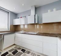 A bright kitchen with minimalist furniture and appliances in a 4-room apartment.