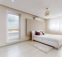 A bedroom in a 4-room apartment with a bed, air conditioning, windows, a painting, and a bright interior.