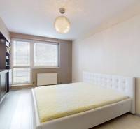 Bright bedroom with a built-in wardrobe and bed in a 4-room apartment.